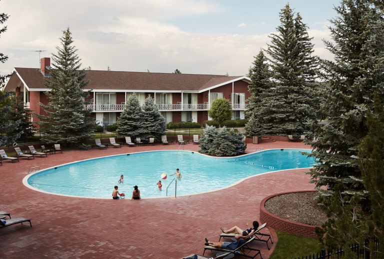Children and adults playing in the outdoor pool at the Little America Hotel in Cheyenne, WY.