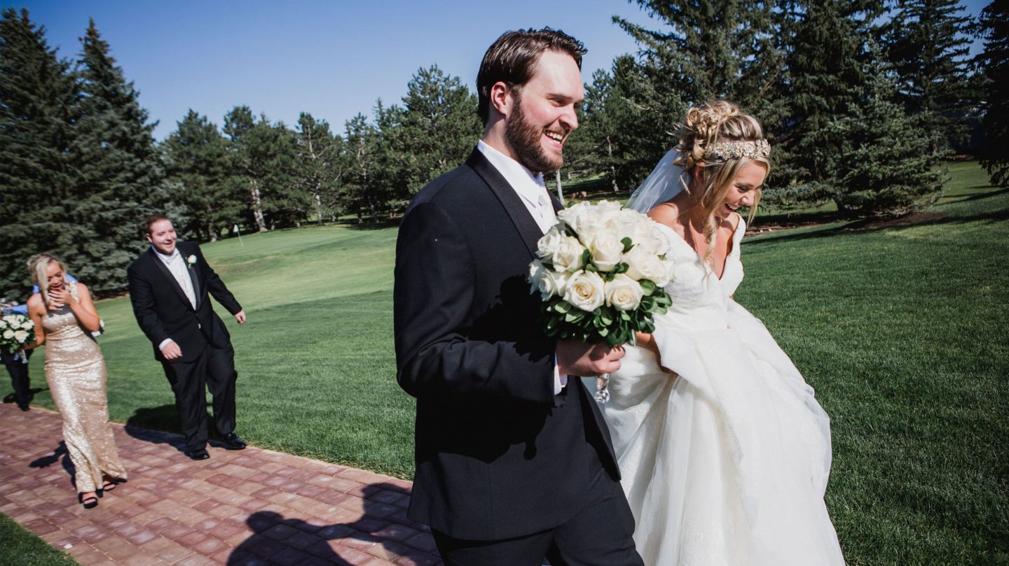 Bride and groom walking on the beautiful summer landscape at the Little America Hotel in Cheyenne.