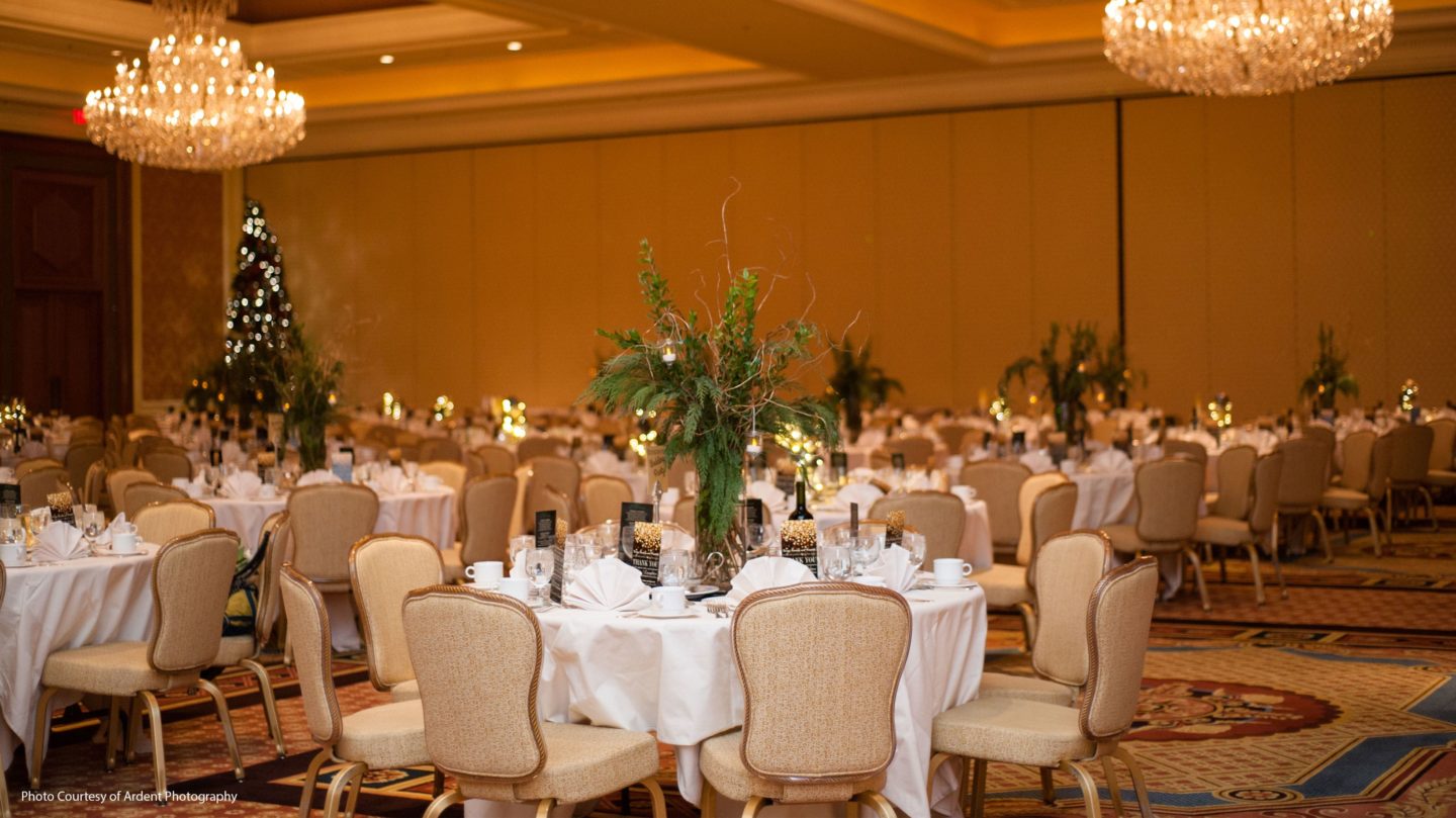 The Grand Ballroom set for dinner reception with floral centerpieces and table settings.
