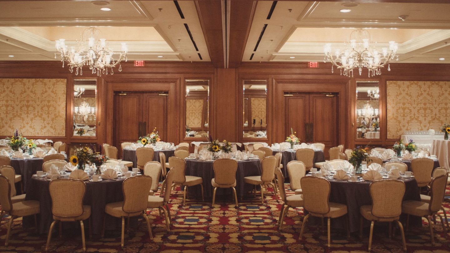 The Wyoming room set for dinner reception with floral centerpieces and table settings.