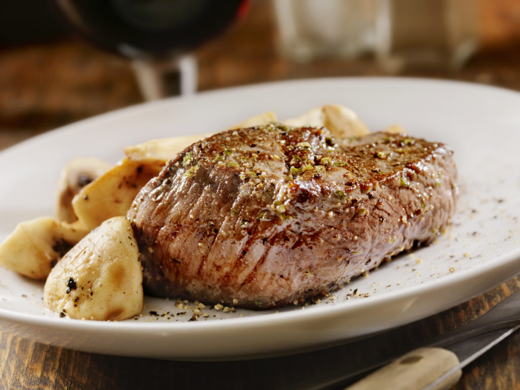 Close up of a plate with seasoned stake and potatos.