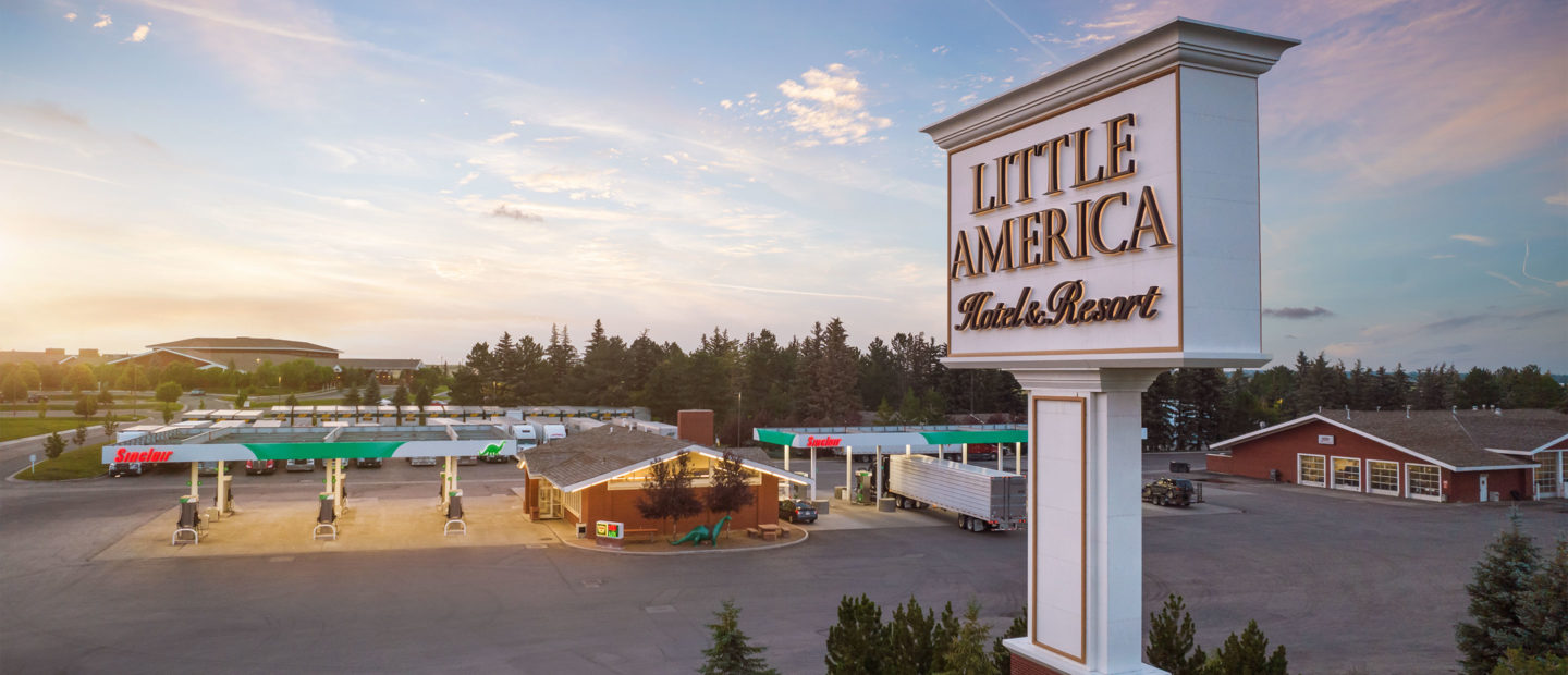 Drone shot of the Little America Hotel and Resort sign and the Sinclair Gas stations near the Travel Center
