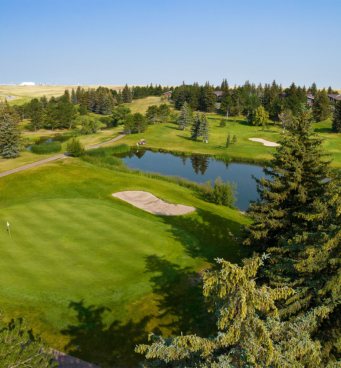 Drone shot of the Little America Cheyenne Golf Course with a lake in the middle.