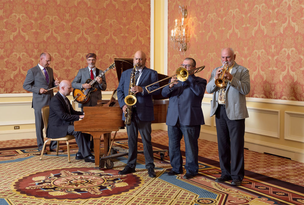 A jazz band performing around a piano at Little America Cheyenne.