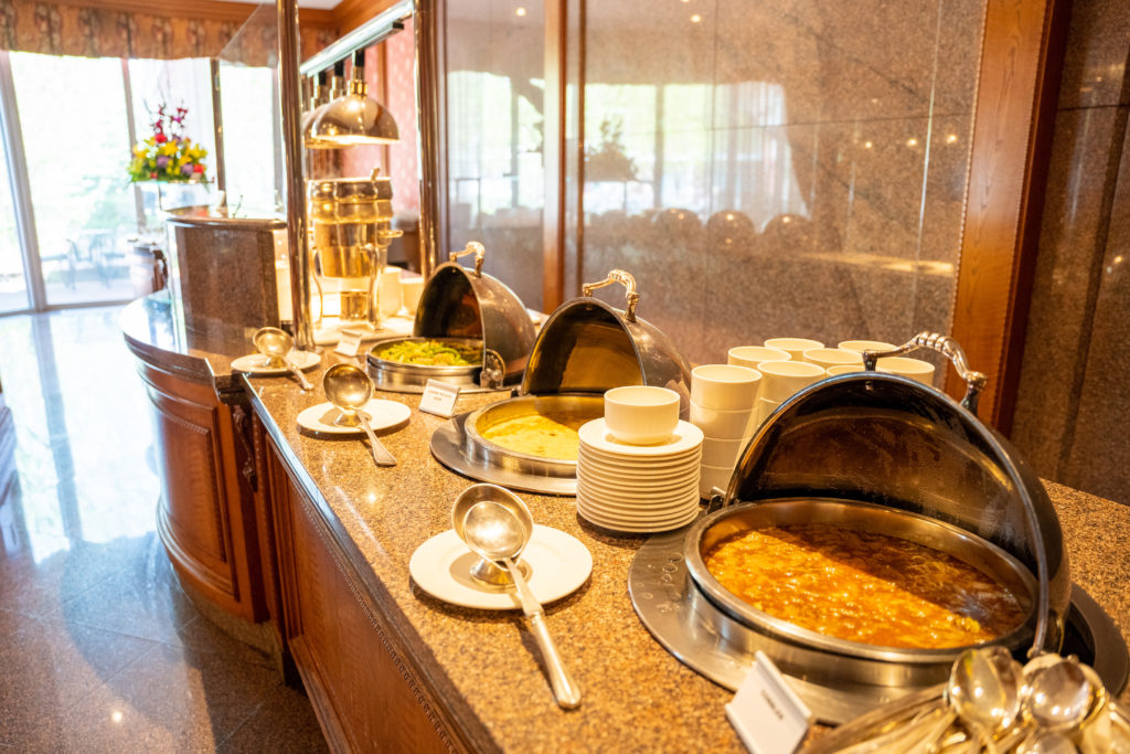 A picture of several buffet stations full of food options.